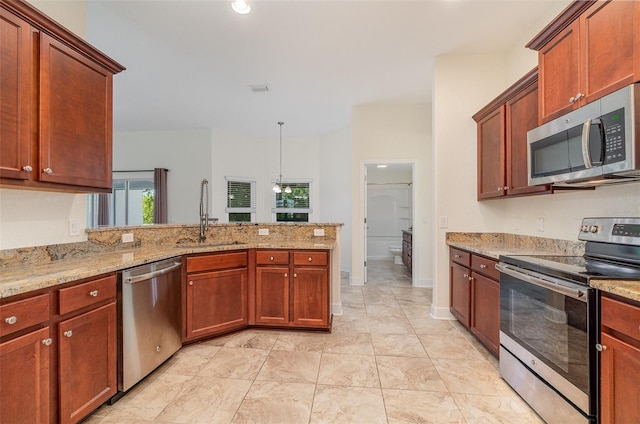 kitchen with visible vents, appliances with stainless steel finishes, light stone counters, a peninsula, and a sink