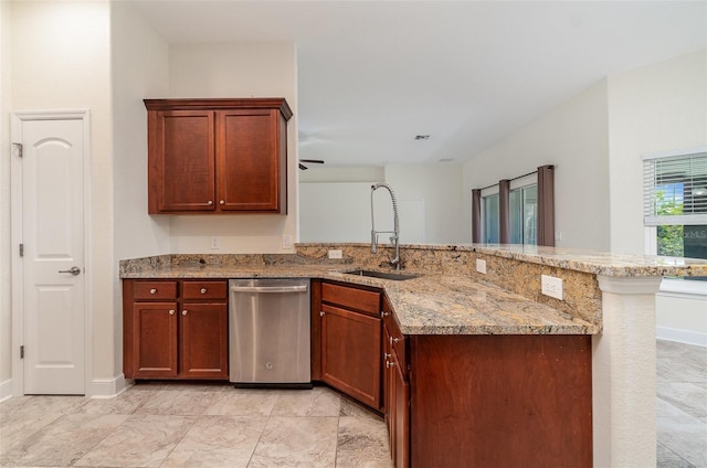 kitchen with baseboards, dishwasher, a peninsula, light stone countertops, and a sink