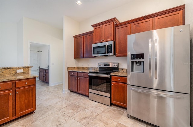 kitchen featuring stainless steel appliances, recessed lighting, baseboards, and light stone countertops