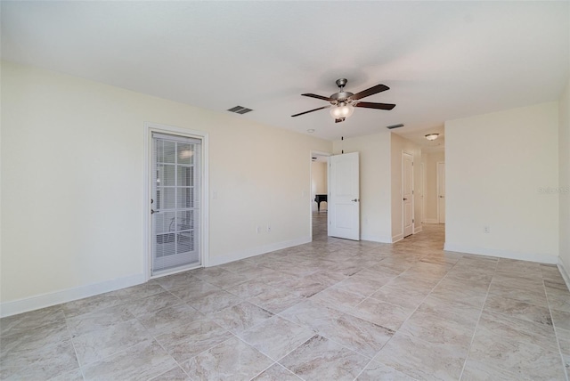 empty room with a ceiling fan, visible vents, and baseboards