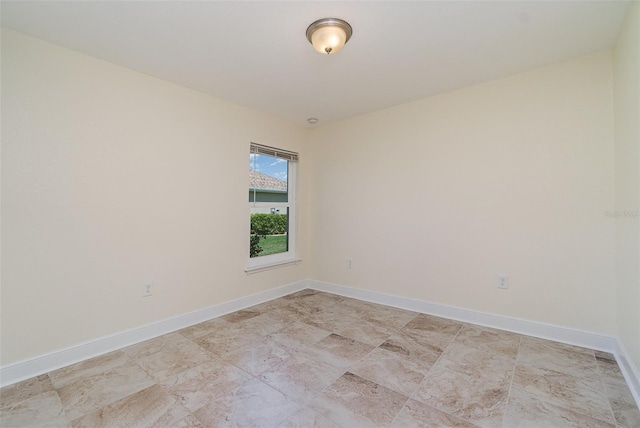 unfurnished room with baseboards