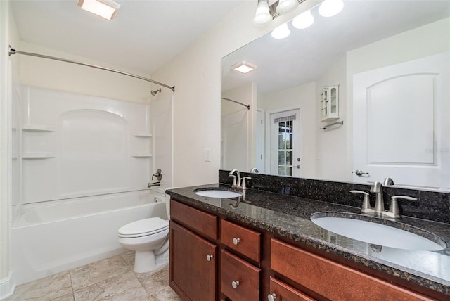 bathroom featuring washtub / shower combination, double vanity, a sink, and toilet