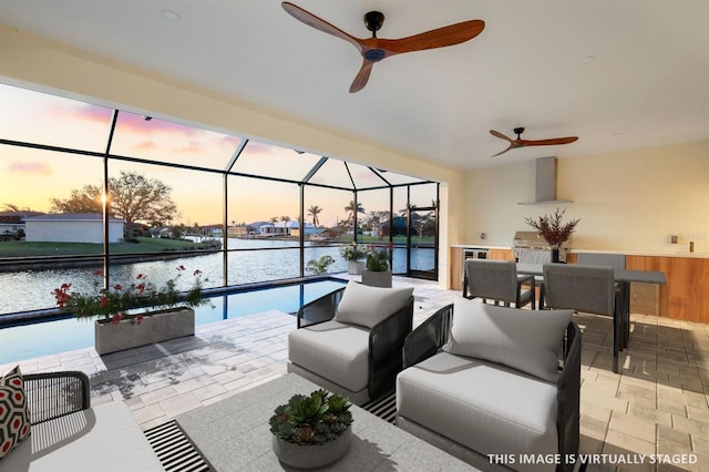 view of patio / terrace featuring ceiling fan, a water view, a lanai, an outdoor hangout area, and a grill