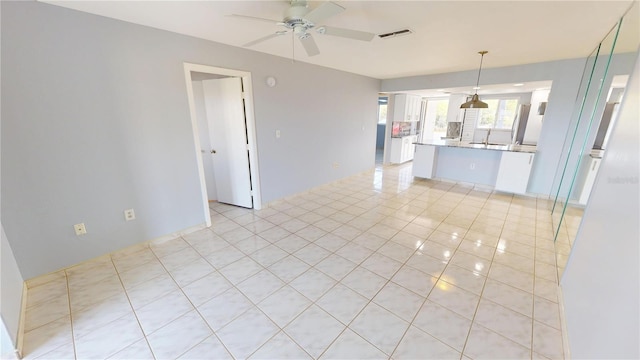 interior space with visible vents, ceiling fan, and light tile patterned floors