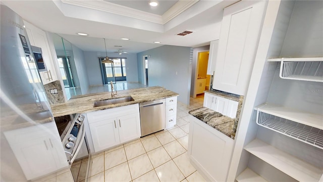 kitchen with a sink, visible vents, white cabinets, appliances with stainless steel finishes, and a raised ceiling