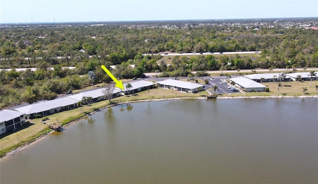 birds eye view of property featuring a water view and a view of trees