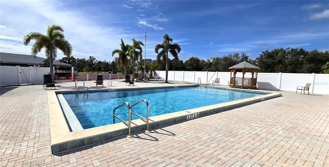 community pool featuring a patio area, fence, and a gazebo