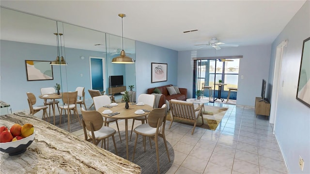25225 Rampart Blvd Unit 604, Punta Gorda, FL 33983 - dining room featuring light tile patterned floors, a ceiling fan, and baseboards