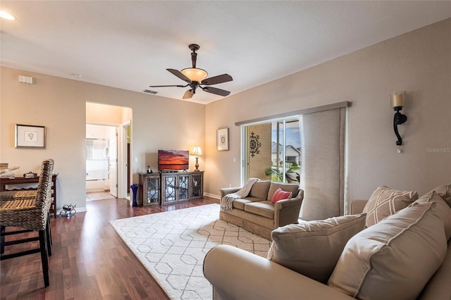 24321 Kintail Ct, Punta Gorda, FL 33980 - living area featuring dark wood-type flooring, visible vents, baseboards, and a ceiling fan