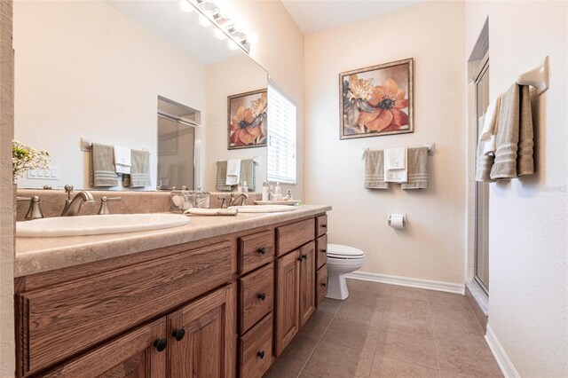 24321 Kintail Ct, Punta Gorda, FL 33980 - full bathroom featuring a sink, toilet, a shower stall, and double vanity