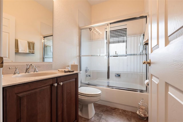 24321 Kintail Ct, Punta Gorda, FL 33980 - full bath with bath / shower combo with glass door, vanity, toilet, and tile patterned flooring