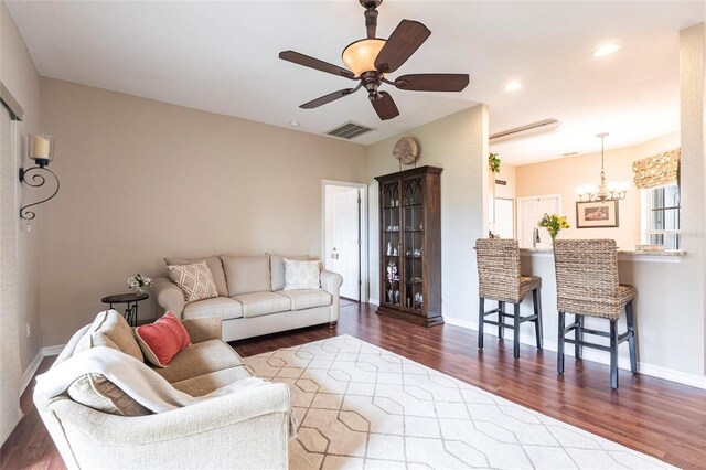 24321 Kintail Ct, Punta Gorda, FL 33980 - living room featuring ceiling fan with notable chandelier, visible vents, recessed lighting, wood finished floors, and baseboards