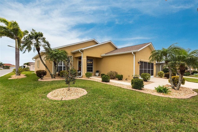24321 Kintail Ct, Punta Gorda, FL 33980 - view of front of home featuring an attached garage, stucco siding, a front lawn, and concrete driveway
