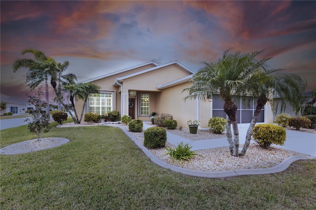 24321 Kintail Ct, Punta Gorda, FL 33980 - ranch-style house with stucco siding and a front lawn