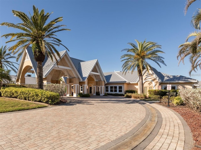 24321 Kintail Ct, Punta Gorda, FL 33980 - view of front of home with a standing seam roof, metal roof, stucco siding, and curved driveway