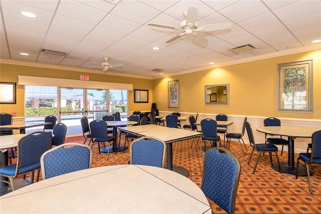24321 Kintail Ct, Punta Gorda, FL 33980 - carpeted dining space with crown molding, visible vents, and a ceiling fan