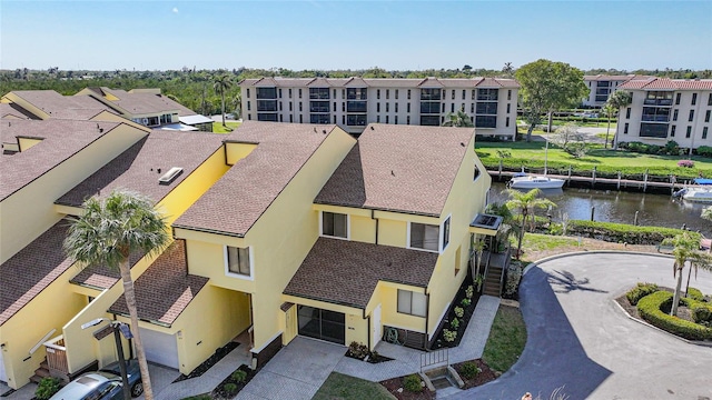 drone / aerial view with a residential view and a water view