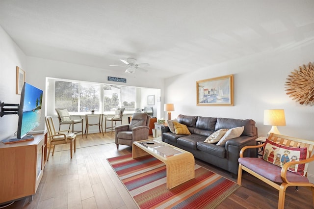 living area featuring a ceiling fan and wood-type flooring