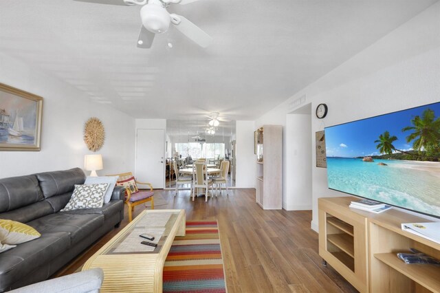 living area with ceiling fan and wood finished floors