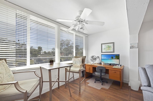 office space with ceiling fan, baseboards, and wood finished floors