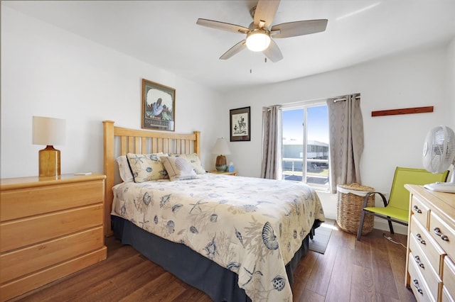 bedroom with dark wood-type flooring, access to outside, and a ceiling fan