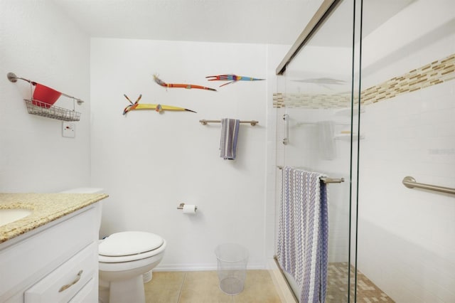 full bathroom with tile patterned floors, toilet, a stall shower, baseboards, and vanity