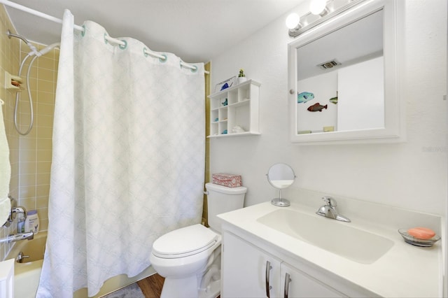 bathroom with visible vents, vanity, toilet, and shower / tub combo