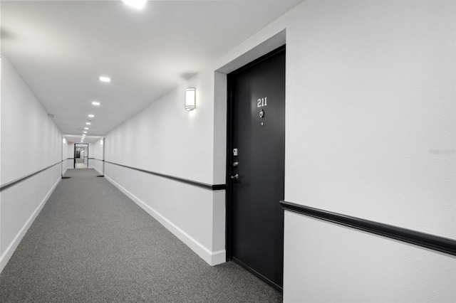 hallway with recessed lighting, baseboards, and carpet floors