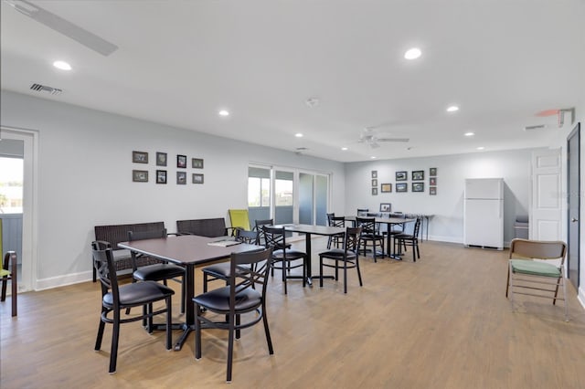 dining space with plenty of natural light, wood finished floors, recessed lighting, and baseboards