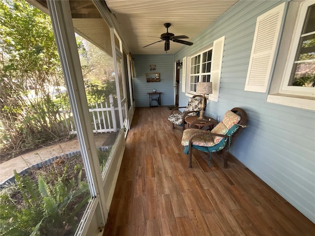 sunroom featuring a ceiling fan