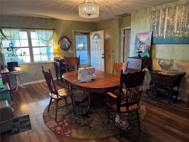 dining area featuring wood finished floors and baseboards