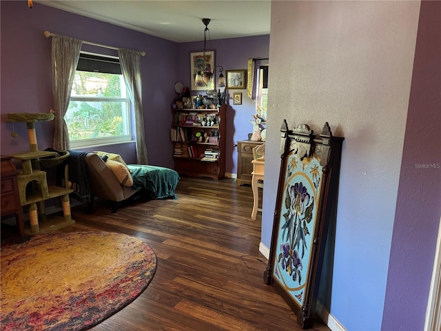 sitting room with baseboards and wood finished floors