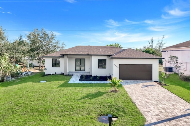 view of front facade with an attached garage, a front yard, decorative driveway, and stucco siding