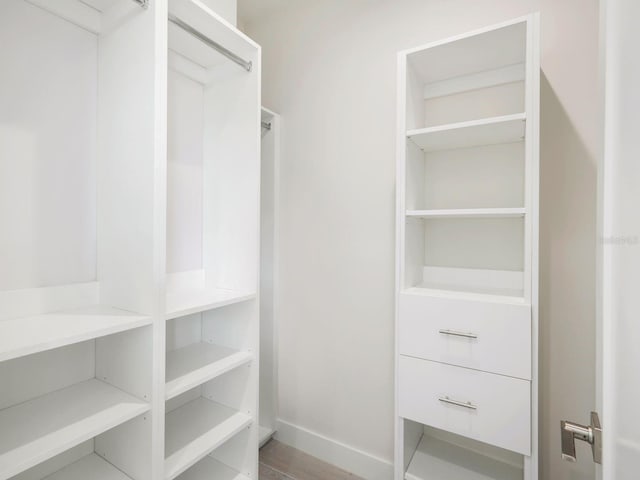 spacious closet with wood finished floors