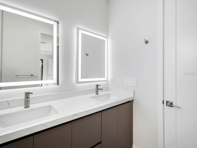 full bath featuring double vanity and a sink