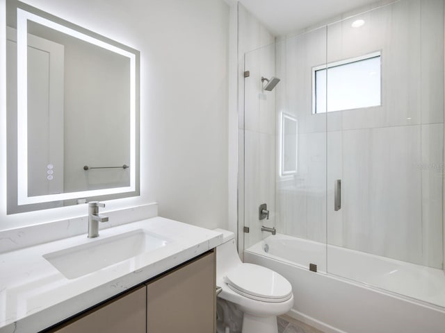 full bathroom featuring toilet, bathing tub / shower combination, and vanity