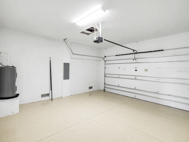 garage featuring water heater, electric panel, and a garage door opener