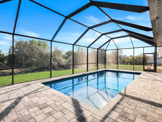 outdoor pool with a patio, a yard, and a lanai