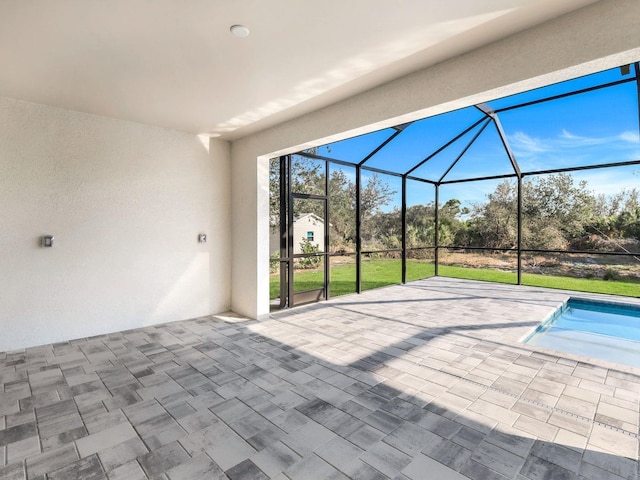 view of patio featuring glass enclosure and an outdoor pool