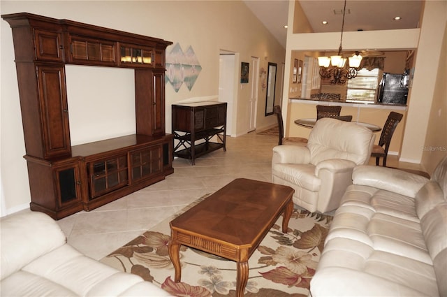 living room with a notable chandelier, light tile patterned floors, recessed lighting, vaulted ceiling, and baseboards