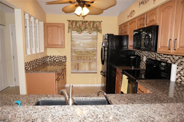 kitchen featuring decorative backsplash, a ceiling fan, light stone countertops, black appliances, and a sink