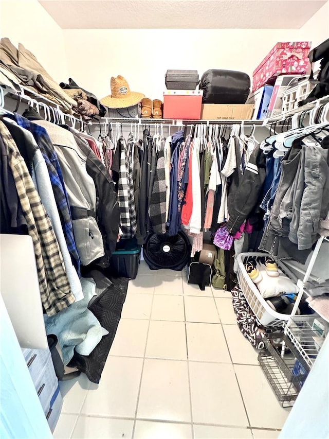 walk in closet with tile patterned floors