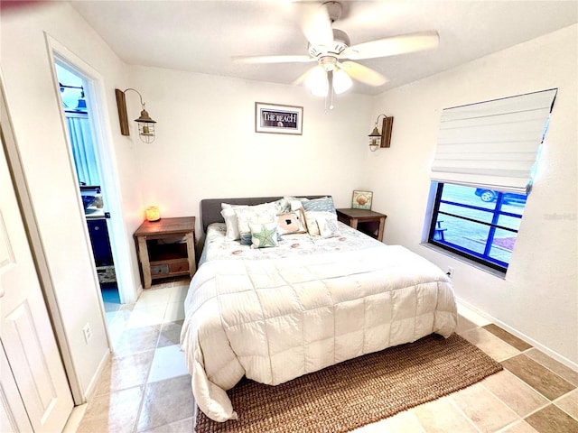 bedroom featuring a ceiling fan and baseboards