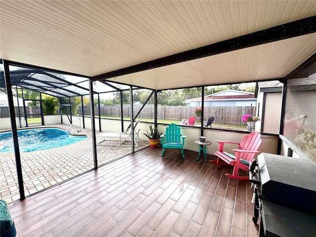 sunroom featuring beamed ceiling