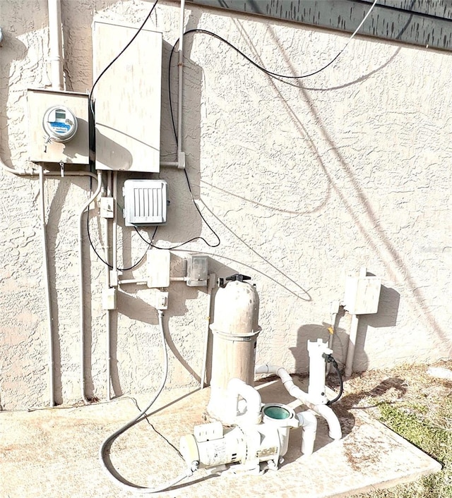 exterior details with electric meter and pump