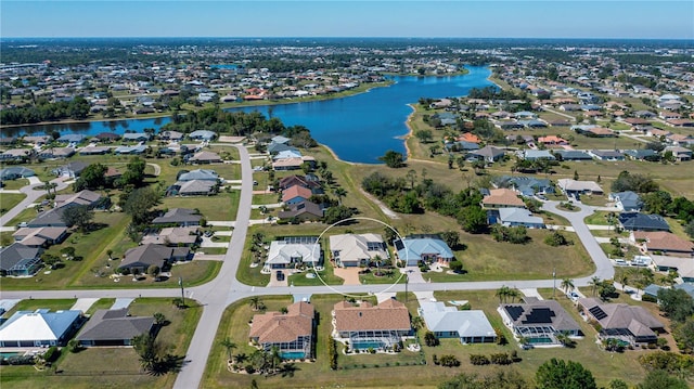 drone / aerial view featuring a residential view and a water view