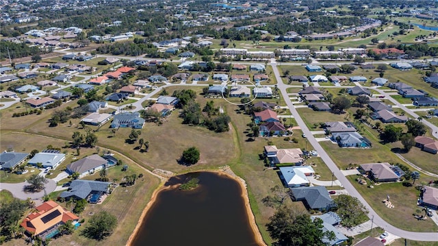 birds eye view of property featuring a water view and a residential view