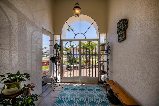 exterior space with a gate and stucco siding