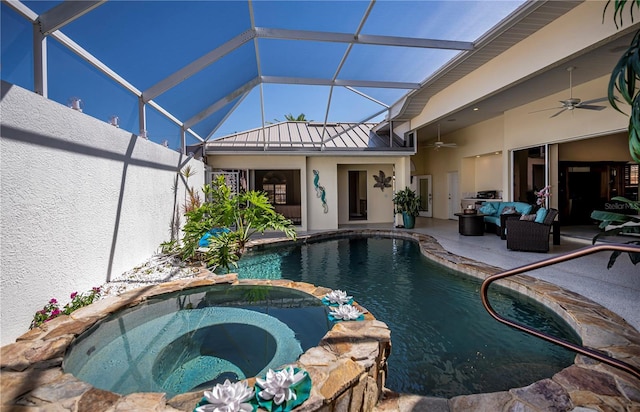 view of swimming pool featuring ceiling fan, a patio, a lanai, and a pool with connected hot tub