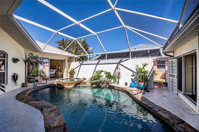 view of pool with glass enclosure, a patio, and a pool with connected hot tub